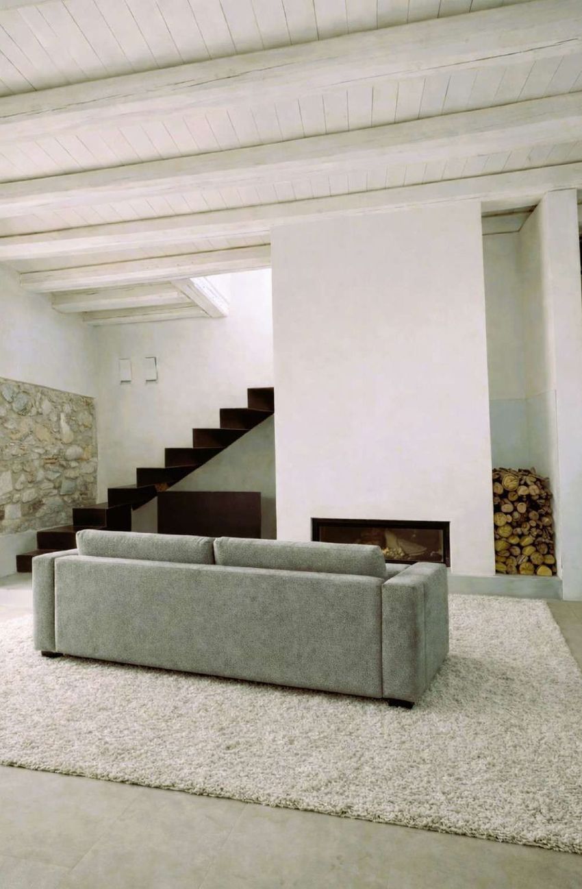 Living room with stone wall and fireplace